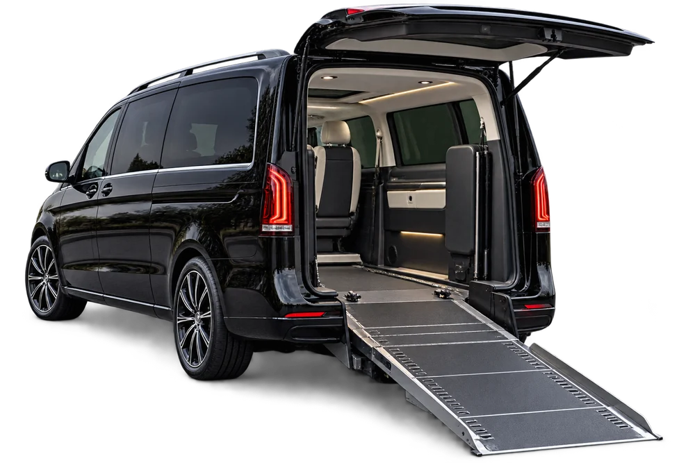 A high-roof passenger van in profile against a plain panel, representative of the larger vehicles